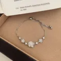 Elegant silver camellia flower bracelet with sparkling zirconia and pearl, adjustable chain. - TSW45 White Camellia Flower Bracelet
