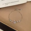Adjustable silver-tone bracelet featuring a cubic zirconia moon and star charm for daily wear. - TSW19 Star and Moon Bracelet