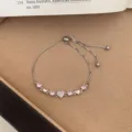 Elegant silver-tone slider bracelet featuring sparkling pink heart cubic zirconia charms. - TSW35 Pink Heart Charm Bracelet