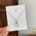 Silver lucky bag pendant necklace on display card, minimalist chic style daily jewelry accessory. - TXL93 Jade Money Bag Necklace