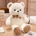 Cute teddy bear plush toy detail showing soft cream fur, patterned bow tie and paw prints. - White Teddy Bear / 40 cm