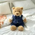 Close-up of a cute fluffy teddy bear wearing a stylish blue vest and bow tie set on a cozy bed. - Navy Blue Suit / Fits 28cm Size