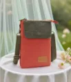 Close-up detail of the canvas crossbody phone bag featuring a textured flap and leather patch. - Solid Color 5-Layer Style / Orange