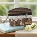 Close-up detail of the ethnic style floral fabric coin pouch with double zipper and lace trim. - Light Orange Morning Glory