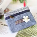 Small denim coin purse with houndstooth pattern, zipper closure, and floral fabric label. - Coin Purse / Plain Blue