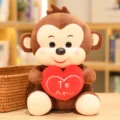 Detailed view of cute brown plush monkey toy holding a red heart with romantic love embroidery. - Heart Holding Monkey / 20cm / Brown