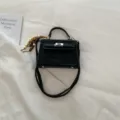 Black suede top handle crossbody bag with metal lock closure and wooden bead pendant for women. - With Pendant / Black