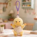 Cute yellow duck plush toy keychain with purple hanging loop and cute bib pendant for bags. - Yellow Duck