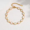 Gold plated oval bezel abalone shell bracelet detail view, elegant mother of pearl wrist jewelry. - Oval / White