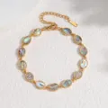 Gold-plated oval abalone shell bracelet detail shot showing natural iridescent pearl texture. - Oval / Colorful