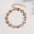 Close-up detail showcasing the gold-plated bezel-set round abalone shell bracelet links. - Round / Colorful