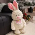 Fluffy plush rabbit toy with pink checkered bib and cute flower decoration, cozy variant. - White Rabbit with Bib