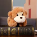 Close-up detail of cute brown plush toy with soft fur and beige face on decorative book. - Monkey