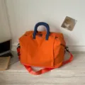 Orange travel duffel bag with blue handles large capacity portable casual luggage bag. - Orange
