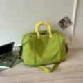 Large capacity green travel duffel bag with yellow handles, lightweight and expandable design. - Green