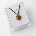 Natural tiger's eye gemstone cat paw pendant necklace with brown braided cord in clear box. - Tiger's Eye