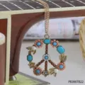 Retro hippie peace sign pendant necklace with turquoise stones and gold chain detail close up. - One Size / Peace Symbol Necklace