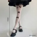 Collant a rete bianchi Lolita con fiocchi neri e design cavo carino per cosplay e feste. - Calze a Rete Bianche con Fiocco Nero