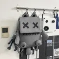 Grey cute cartoon backpack with XX eyes, stylish school bag for students and travel. - Gray With Pendant