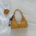 Yellow woven underarm shoulder bag for women, stylish faux leather handbag with buckle detail. - With Charm / Yellow