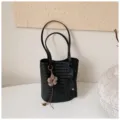 Black woven bucket bag, stylish shoulder tote with elegant flower charm and front pouch. - With Charm / Black