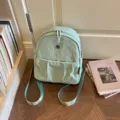 Light green minimalist women's casual backpack, lightweight nylon commuting daypack for daily wear. - Green