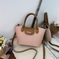 Stylish pink shoulder handbag with brown contrast top handle and adjustable crossbody strap for women. - No Pendant / Pink