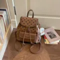 Brown polka dot fashion backpack with front pocket and cute dog charm for daily commute. - Brown With Pendant