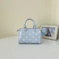 Stylish light blue polka dot barrel bag, elegant top handle design for daily chic outfits. - Blue Without Charm