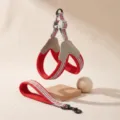 Close-up of red mesh dog harness and leash set with grey stripes and leather-like patch. - China Red