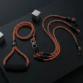 Multi-dog leash detail shot, orange and black woven rope with comfortable handle. - Triple 3-Pet / Orange