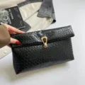 Black woven clutch bag for women, stylish folded edge design, chic underarm purse featuring gold lock. - Black