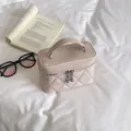 Beige quilted cosmetic vanity bag with top handle and chic zipper, perfect for daily makeup storage. - Pink