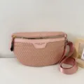 Pink woven leather crossbody bag detail, featuring classic intrecciato style and zipper. - Pink
