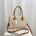 Korean style canvas square bag with brown leather handles and chic flower pendant for women. - With Charm / Off White