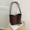 Dark brown woven leather shoulder bag detail, stylish minimal design accessory for women. - Brown