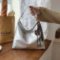 Silver metallic slouchy shoulder bag for women, stylish hobo crossbody handbag with cute charm. - With Pendant / Silver