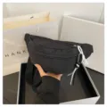 Black nylon fanny pack for women, casual chest bag with wide strap and white zipper pull. - One Size / Black