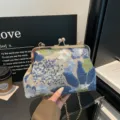 Exquisite detail view of the new Chinese style embroidered sequin handbag with kiss-lock clasp. - Blue