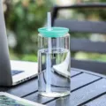 Clear glass tumbler with straw and teal lid, portable beverage cup for office and daily use. - Solid Green
