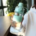 Portable large capacity plastic sports water bottle with straw and scale markings for daily use. - Green