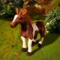 Close-up detail of the brown and white plush horse toy displayed on a mossy background. - 39*45cm / Hucul Horses