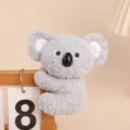 Cute grey koala plush clip toy hanging on wooden calendar, soft companion doll for office desk. - Koala