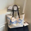 Casual large capacity canvas tote bag with shoulder straps and smiley face graphic design. - Cream White with Pendant