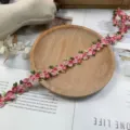 Detail view of colorful 3D flower polyester lace trim, perfect for DIY clothing and crafts decoration. - Rose Red