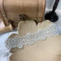 Close up view of the white delicate lace trim, showing intricate floral embroidery pattern. - 5cm / White