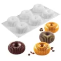 Detailed view of 6 cavity silicone cake mold with finished fluted mousse desserts. - 184467