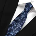 Men's blue floral silk tie detailed close-up shot, perfect for business formal wear. - Aegean Sea Wave Series - Navy Blue
