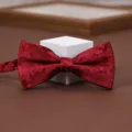 Wine red patterned bow tie detail shot, elegant fabric for men suits, weddings, and formal wear. - Aegean Wave Dark Red Bowtie