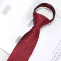 Close up of a red zipper necktie with fine twill texture, displayed on a white decorative book. - 6cm Short Wine Red Striped Zipper Style